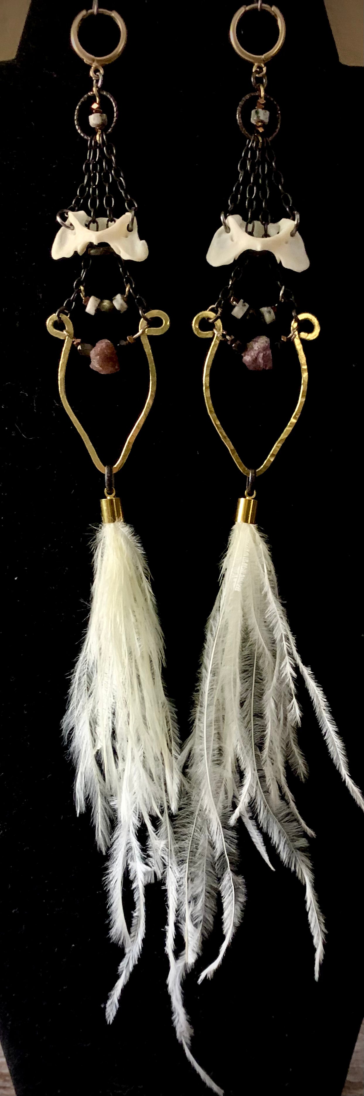 Feathers, neck bone, and ruby earrings